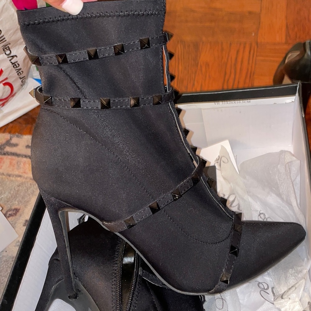 Pointy toe booties with studs and stiletto heels. All black. Slightly worn.